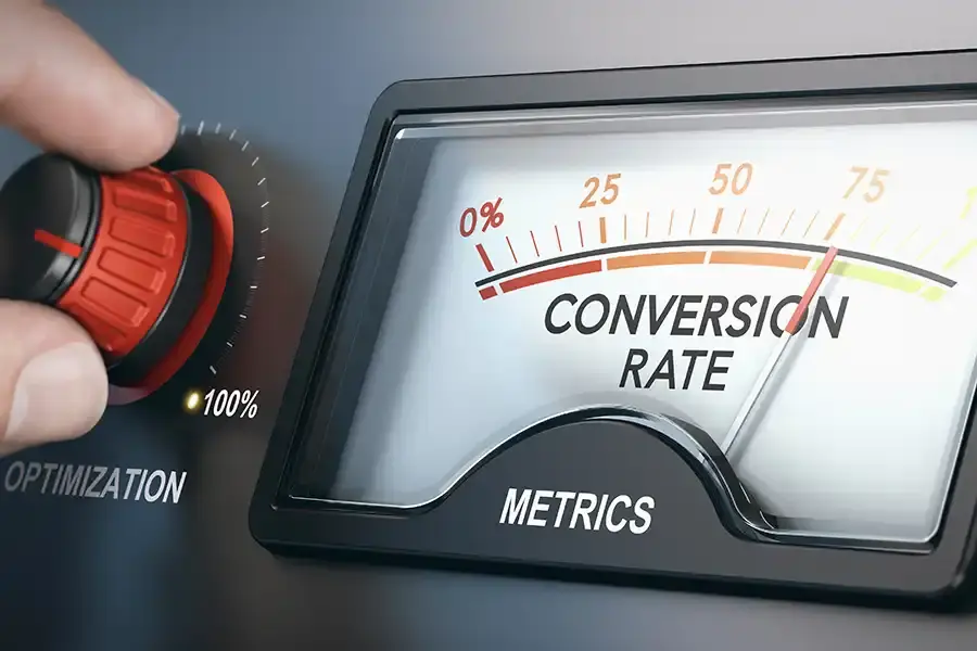 Hand turning optimization dial next to gauge measuring high conversion rate on metrics display